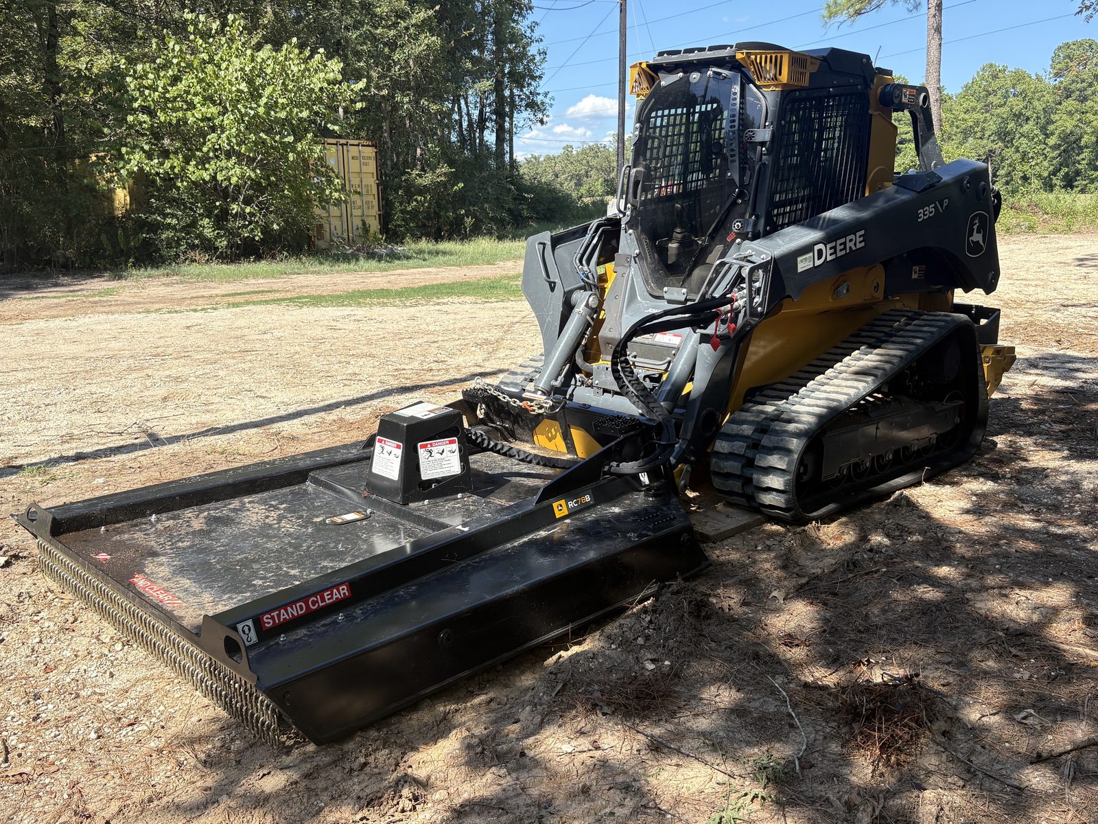 John Deere 335P skid steer with 78 inch rotary cutter brush hog attachment